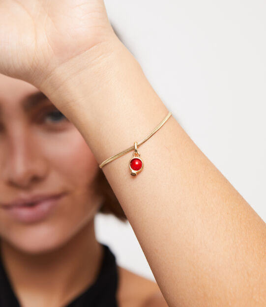 18K gold-plated charm with red stone.